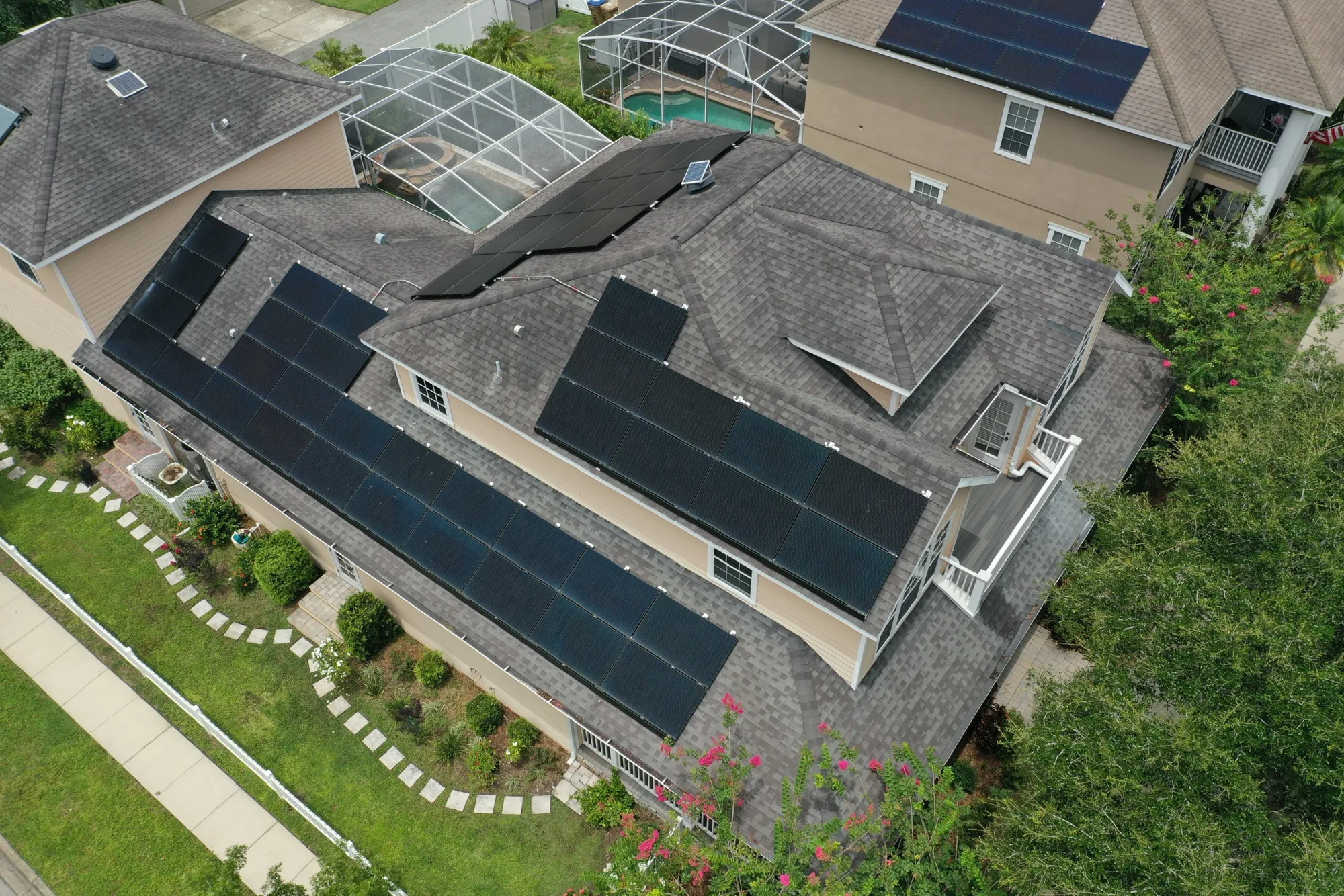 Solar array installed around a screened pool enclosure